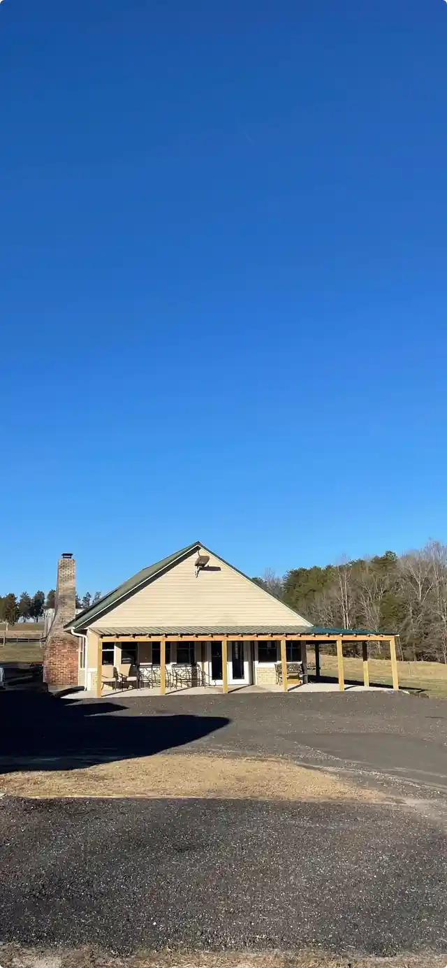 The clubhouse building against a blue sky above the gravel lot